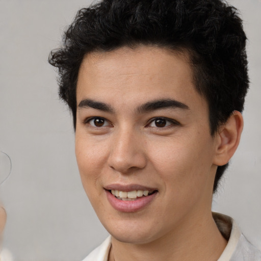 Joyful latino young-adult male with short  brown hair and brown eyes