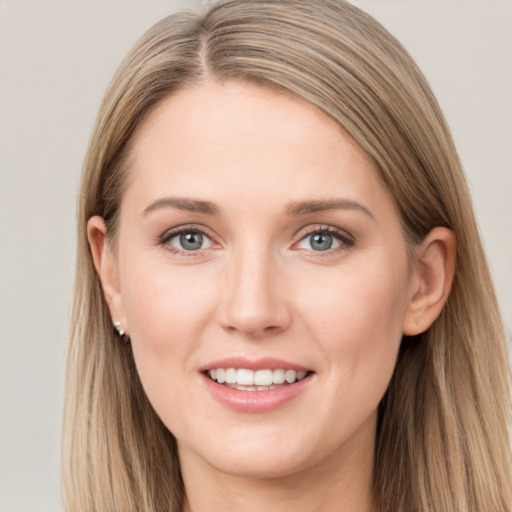 Joyful white young-adult female with long  brown hair and grey eyes