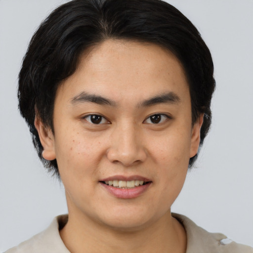 Joyful asian young-adult male with short  brown hair and brown eyes