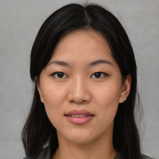 Joyful asian young-adult female with long  black hair and brown eyes