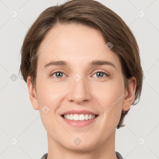 Joyful white young-adult female with short  brown hair and grey eyes