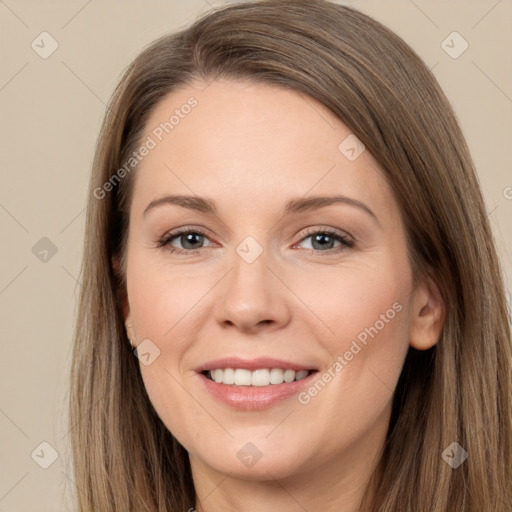 Joyful white young-adult female with long  brown hair and brown eyes