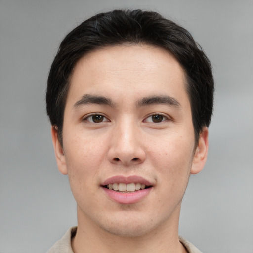 Joyful asian young-adult male with short  brown hair and brown eyes