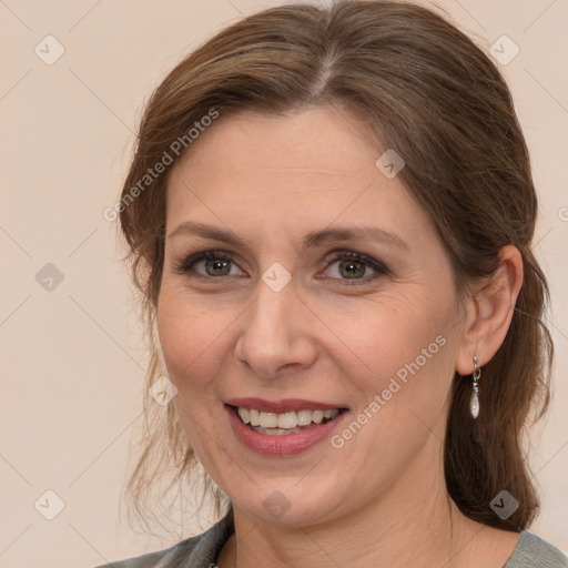 Joyful white adult female with medium  brown hair and grey eyes