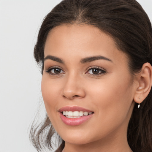 Joyful white young-adult female with long  brown hair and brown eyes