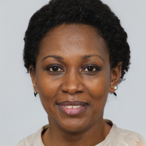 Joyful black adult female with short  black hair and brown eyes