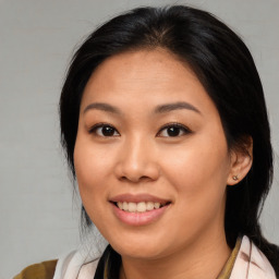 Joyful asian young-adult female with medium  brown hair and brown eyes