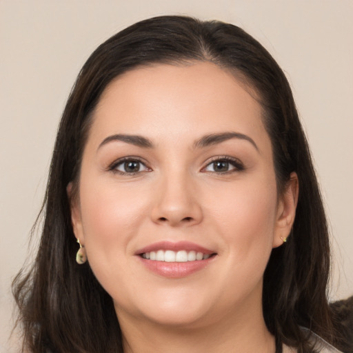 Joyful white young-adult female with long  brown hair and brown eyes