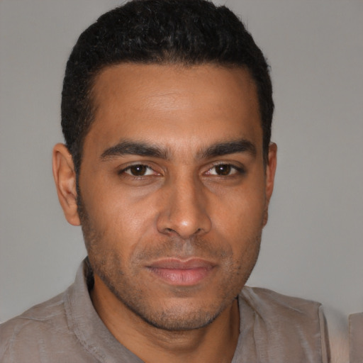 Neutral latino young-adult male with short  brown hair and brown eyes