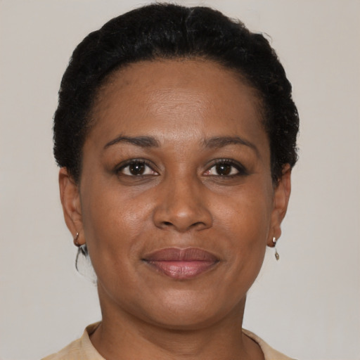 Joyful black adult female with short  brown hair and brown eyes