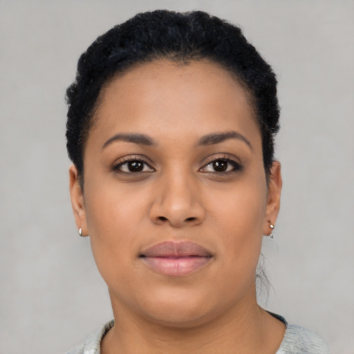 Joyful latino young-adult female with short  black hair and brown eyes