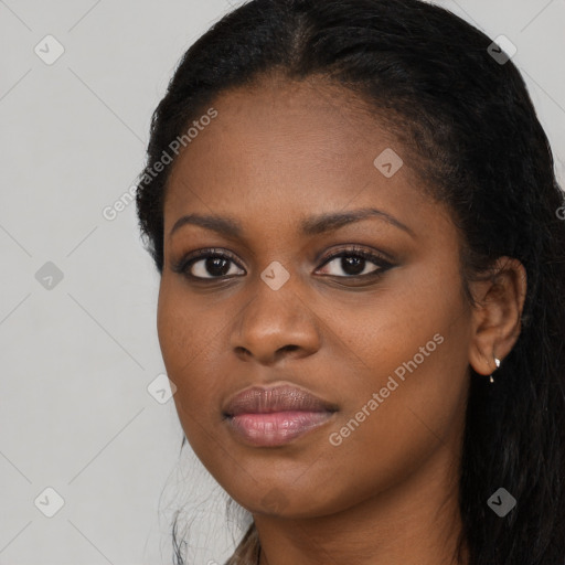 Joyful black young-adult female with long  black hair and brown eyes