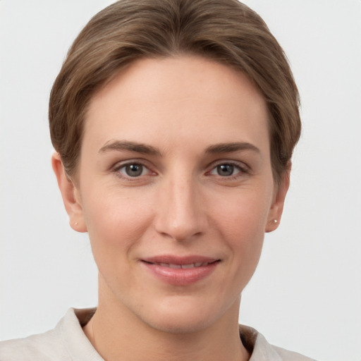 Joyful white young-adult female with short  brown hair and grey eyes