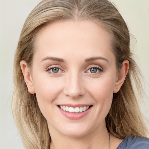 Joyful white young-adult female with long  brown hair and blue eyes