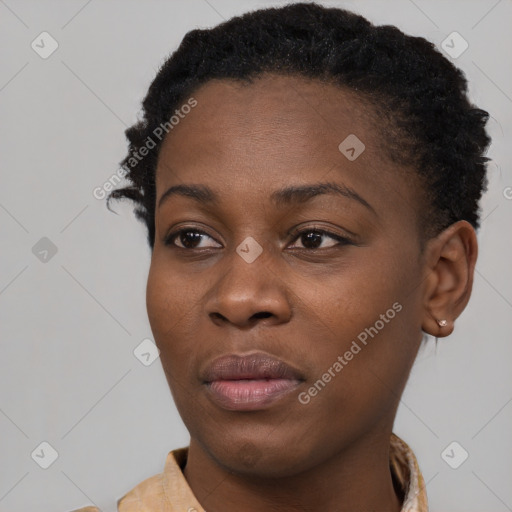 Joyful black young-adult female with short  brown hair and brown eyes