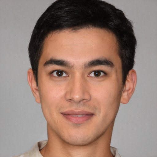 Joyful latino young-adult male with short  brown hair and brown eyes