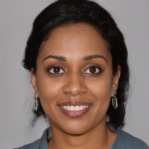 Joyful black young-adult female with medium  black hair and brown eyes