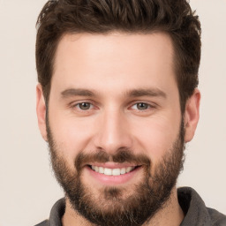 Joyful white young-adult male with short  brown hair and brown eyes