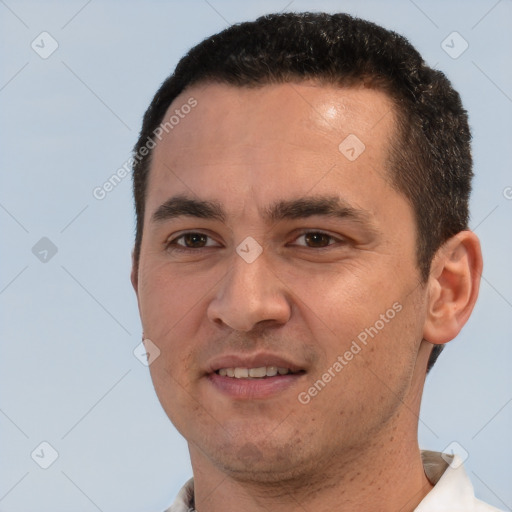 Joyful white young-adult male with short  black hair and brown eyes