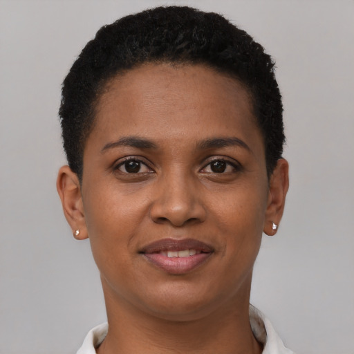 Joyful black young-adult female with short  brown hair and brown eyes