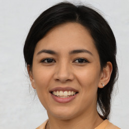 Joyful latino young-adult female with medium  brown hair and brown eyes