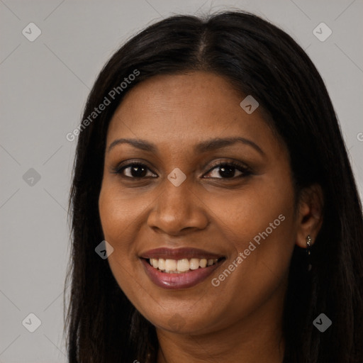 Joyful black young-adult female with long  brown hair and brown eyes