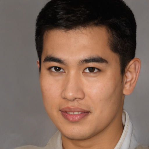 Joyful latino young-adult male with short  brown hair and brown eyes