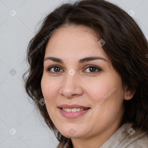 Joyful white adult female with long  brown hair and brown eyes