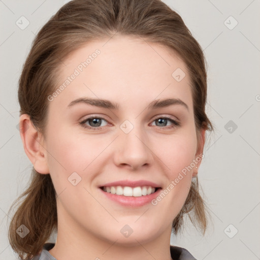 Joyful white young-adult female with medium  brown hair and grey eyes