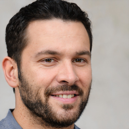 Joyful white adult male with short  brown hair and brown eyes