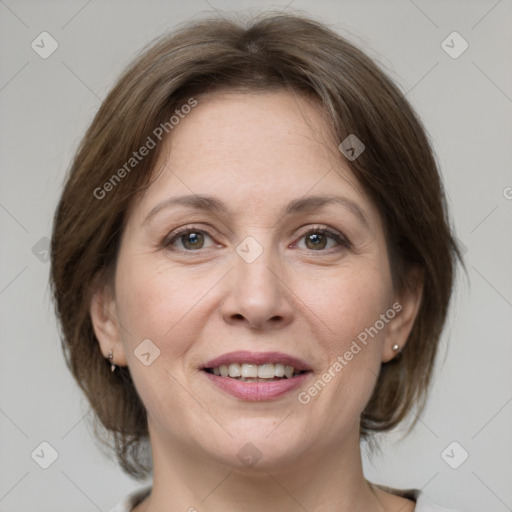 Joyful white adult female with medium  brown hair and grey eyes