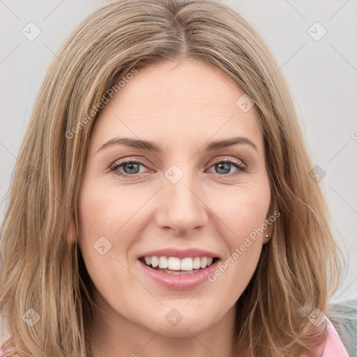 Joyful white young-adult female with long  brown hair and green eyes