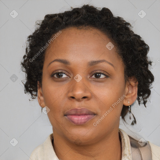 Joyful black adult female with medium  brown hair and brown eyes