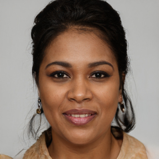 Joyful black young-adult female with medium  brown hair and brown eyes