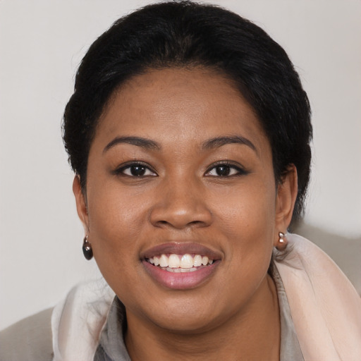 Joyful black young-adult female with medium  brown hair and brown eyes