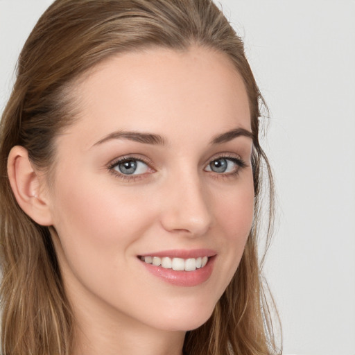 Joyful white young-adult female with long  brown hair and blue eyes