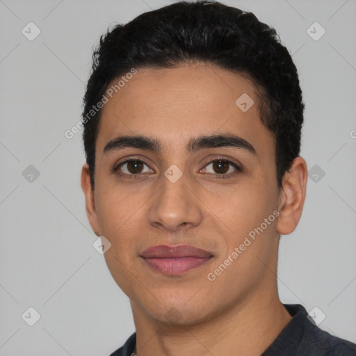 Joyful latino young-adult male with short  black hair and brown eyes