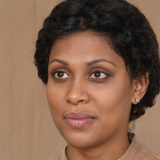 Joyful black young-adult female with medium  brown hair and brown eyes