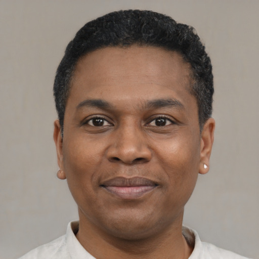 Joyful black young-adult male with short  black hair and brown eyes