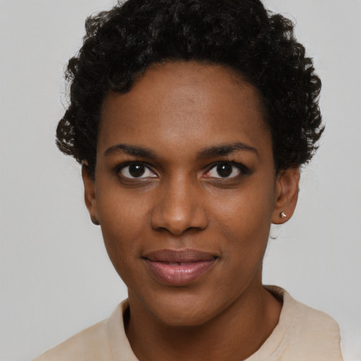 Joyful black young-adult female with short  black hair and brown eyes