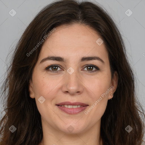 Joyful white adult female with long  brown hair and brown eyes