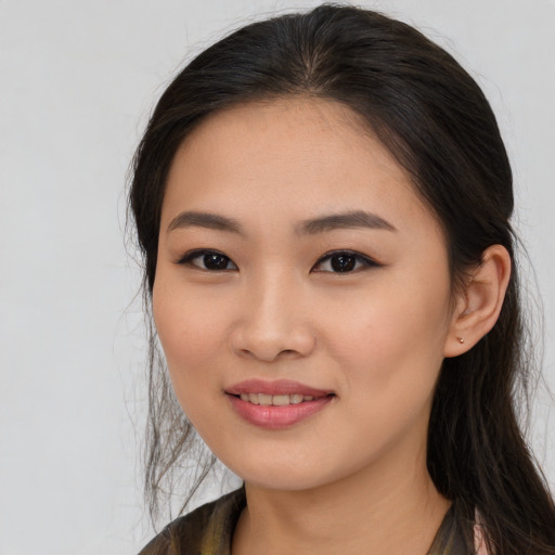 Joyful asian young-adult female with long  brown hair and brown eyes