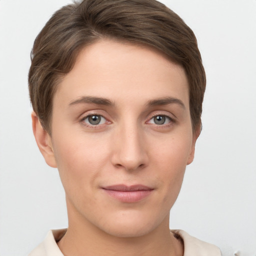 Joyful white young-adult female with short  brown hair and grey eyes