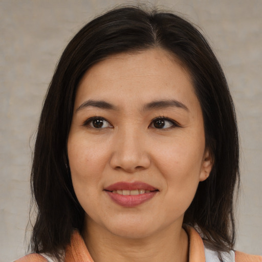 Joyful asian young-adult female with medium  brown hair and brown eyes