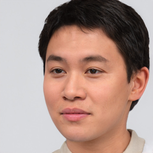 Joyful asian young-adult male with short  brown hair and brown eyes