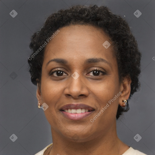 Joyful black adult female with short  brown hair and brown eyes