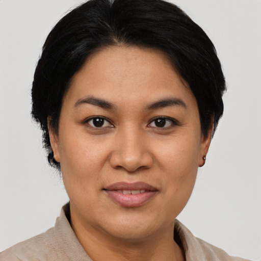 Joyful asian adult female with short  black hair and brown eyes