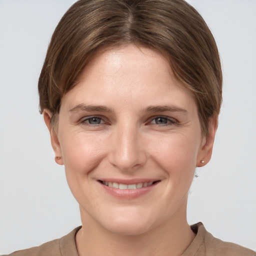 Joyful white young-adult female with short  brown hair and grey eyes