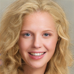 Joyful white young-adult female with long  blond hair and blue eyes