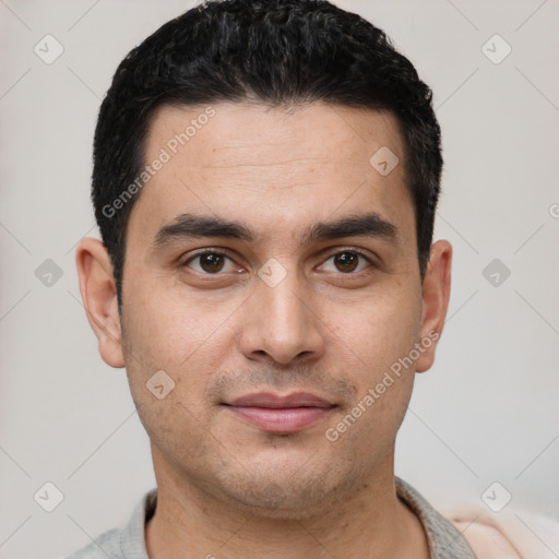 Joyful white young-adult male with short  black hair and brown eyes